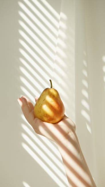 A pear held in warm sunlight